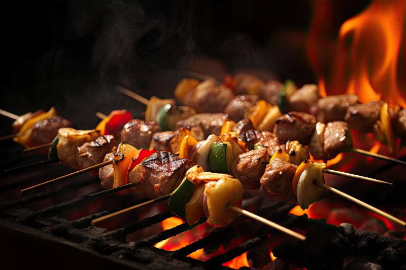 Barbecue skewers meat kebabs with vegetables on flaming grill